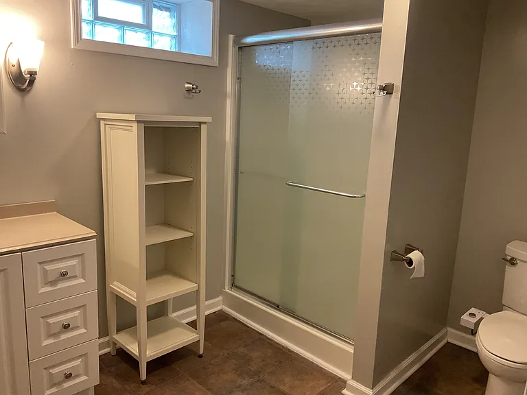 Large walk in shower and daylight window complete the lower level bathroom.