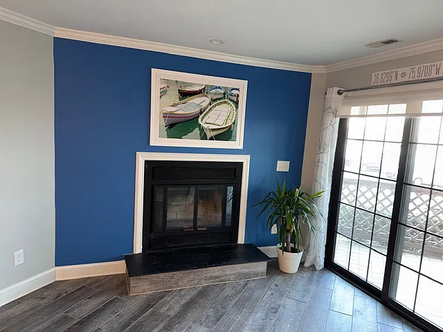Large enclosed patio to the right with beautiful direct views of Rudee Inlet...watch the boats come and go! Sits above parking area, but on first floor.
