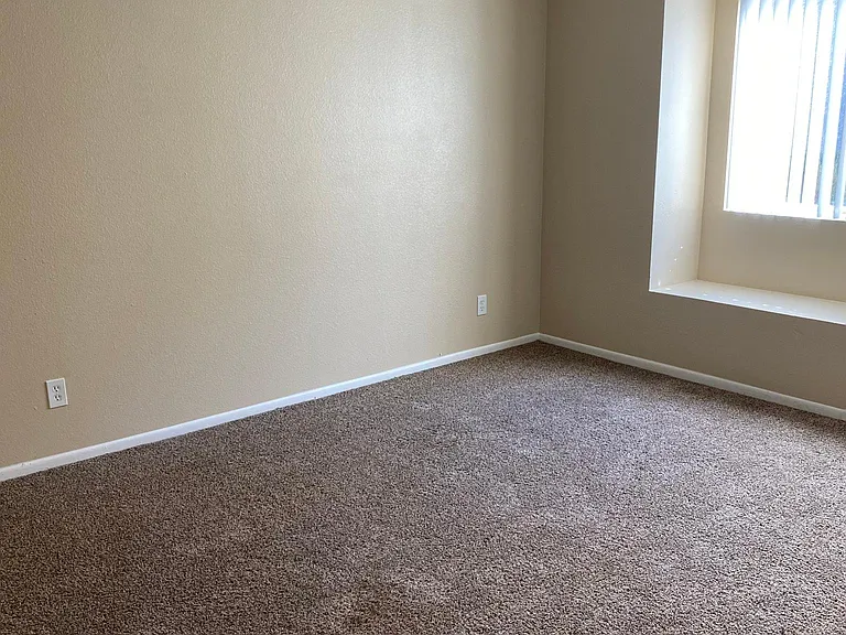 downstairs 2 bedroom - main bedroom with LED ceiling fan and window seat
