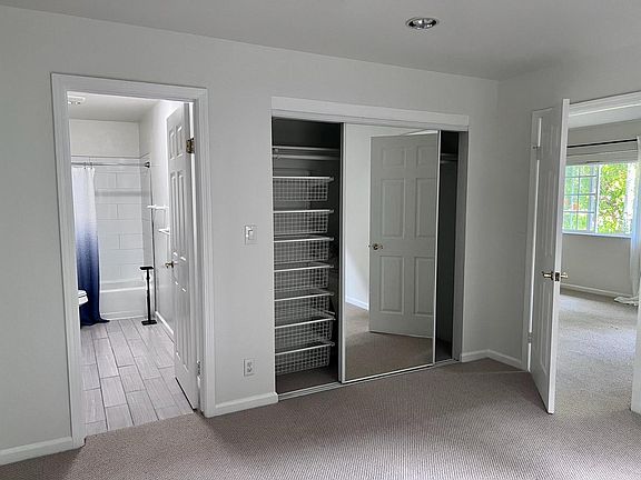 Closet in bedroom with door to bathroom. Washer Dryer located there as well
