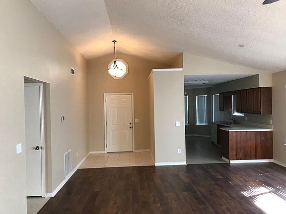 Family room looking into kitchen and front entry. Notice the beautiful wood-laminate flooring!!!