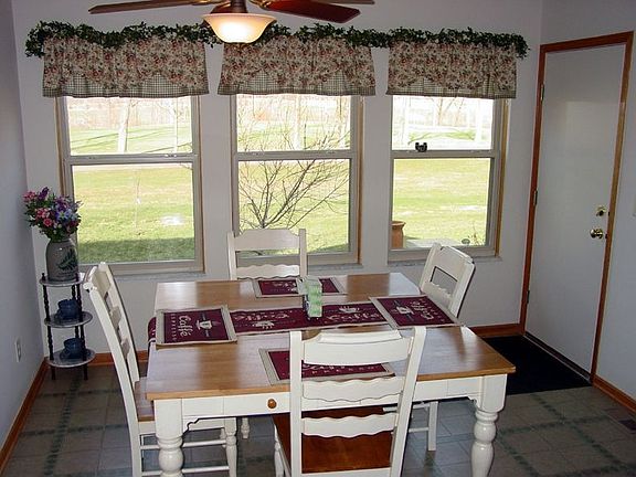 Kitchen dining area looks out at golf course