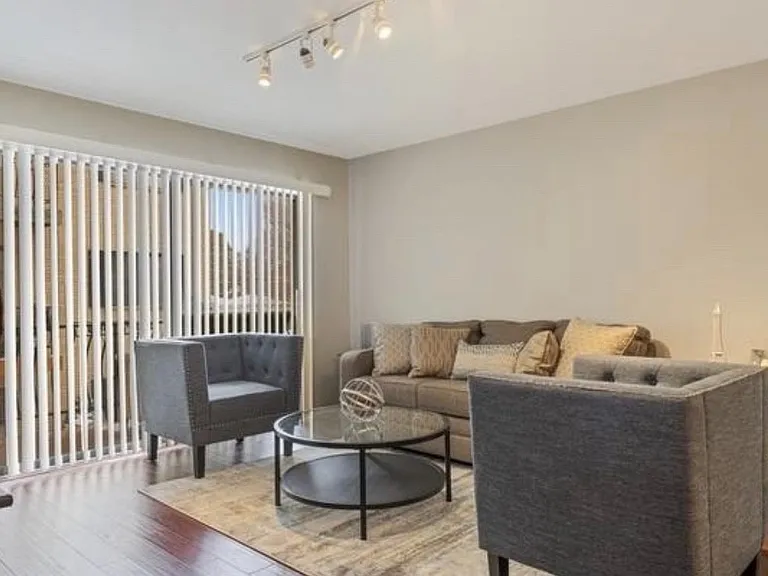 Livingroom with huge sliding doors leading to balcony