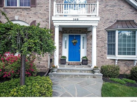 Welcoming Front Door with extensive Blue Stone Walkways, Patio and steps