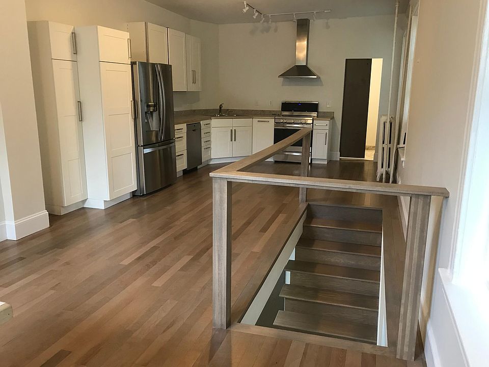 Upstairs main living area with half bath and in unit washer/dryer. Open stairway to lower level