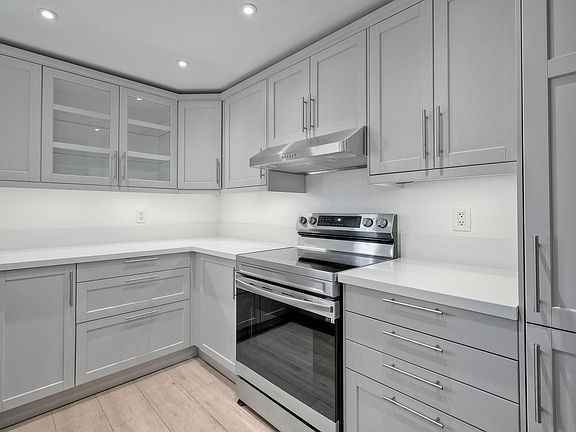 Ample cabinet space and quartz countertop.