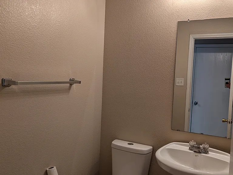 Half bath located on first floor next to kitchen and garage