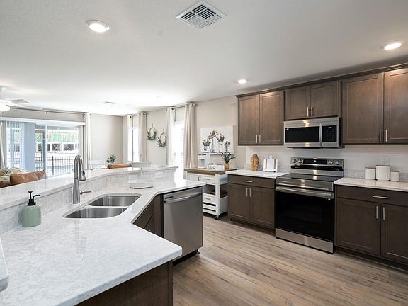 Your spacious kitchen includes ample cabinet and counter space, a pantry, and a butterfly island - M