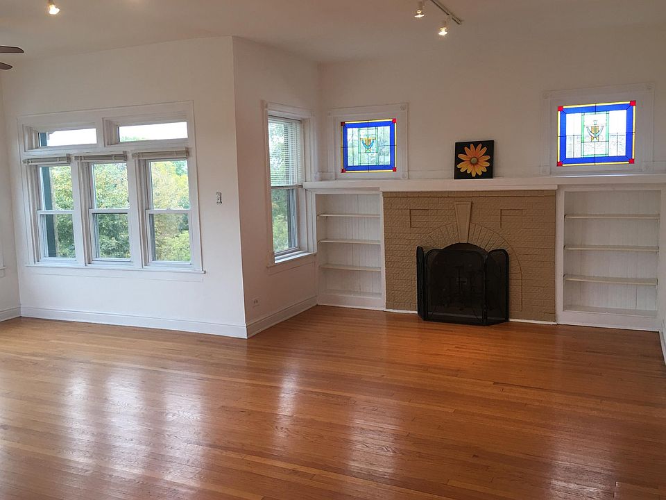 Spacious living room with vintage stained glass and lots of sun