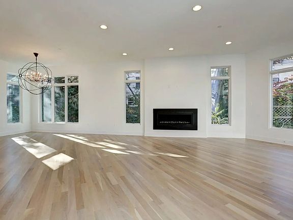 Three windows frame the trees the fire answers back