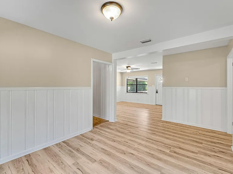 View from dining room to living room. Kitchen is through the door on the left.