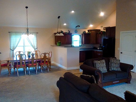 Open design with vaulted ceiling, kitchen, living and dining rooms.