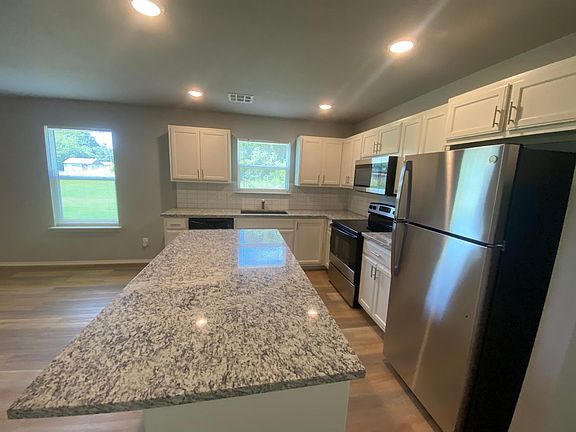 Open kitchen with large island. Refrigerator is included