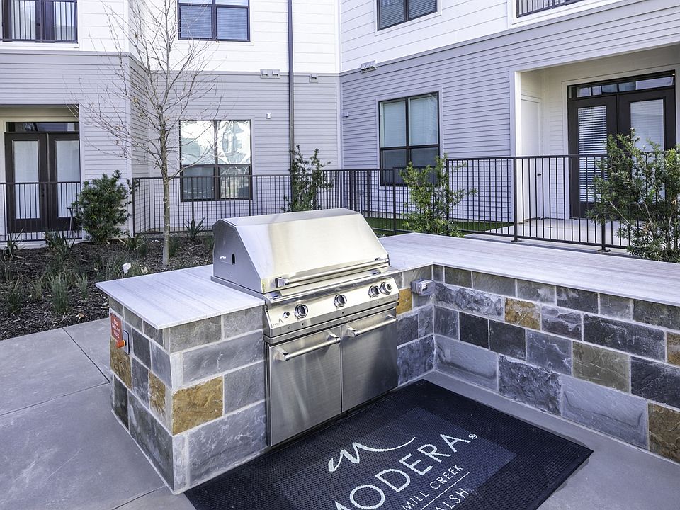 Indulge in outdoor living at its finest on Modera Walsh's lavish outdoor deck, featuring grills, an outdoor kitchen, and inviting al fresco dining areas for memorable gatherings under the open sky.