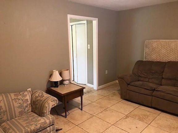 Living room. The apartment features tile floors throughout.