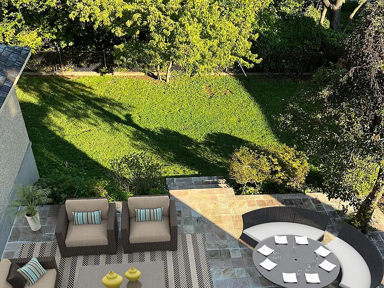 Stone patio designed for entertaining, barbecue and family fun. Spotlights controlled from inside light up the patio and yard to enjoy evening hours. This picture was taken from the outside second floor walkway