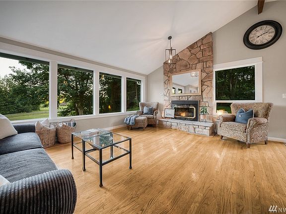 Kick your feet up and take in the comfort of this timeless living room. Warm wood floors, wall of windows & cozy gas fireplace. Vaulted ceiling opens up the spaces and natural flow of the home. 