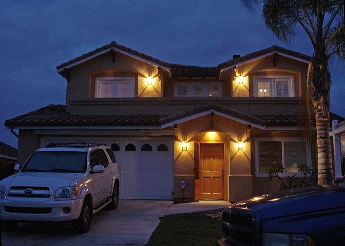 Front lighting, oak entry door, mature queen palm...