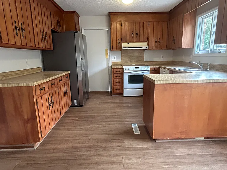 Kitchen with new LVP, fresh paint, ceramic cooktop, French door refrigerator
