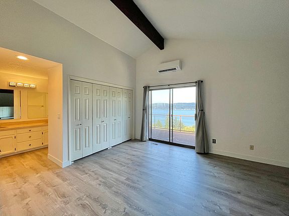 En-suite, closet and sliders to private view deck.