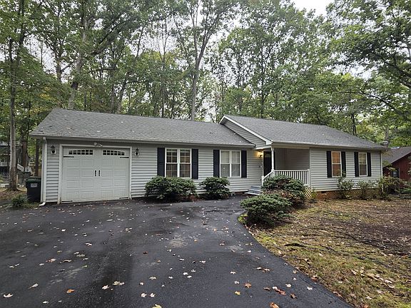 Paved driveway with one car attached garage