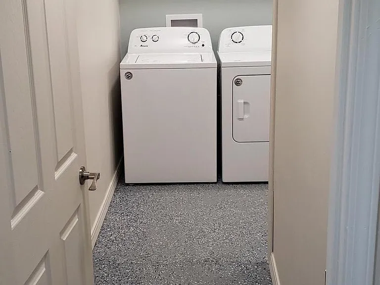 private laundry room with storage.