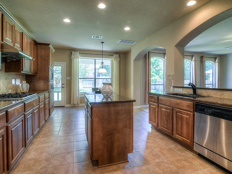 Gleaming granite and tile in this beautiful kitchen. Sure to be a pleasure to cook here and host your party