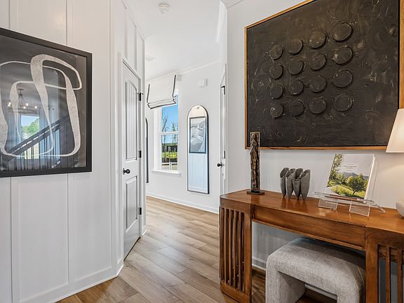 Bright foyer with LVP flooring and room for entryway table in new construction townhome in Loganvill