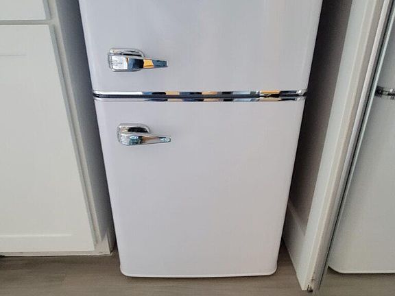 Under the counter retro-style new fridge in all our refreshed studio apartments. Pictured here from Refreshed Studio Apartment #8 - Currently offering a special of first month's rent on this apartment