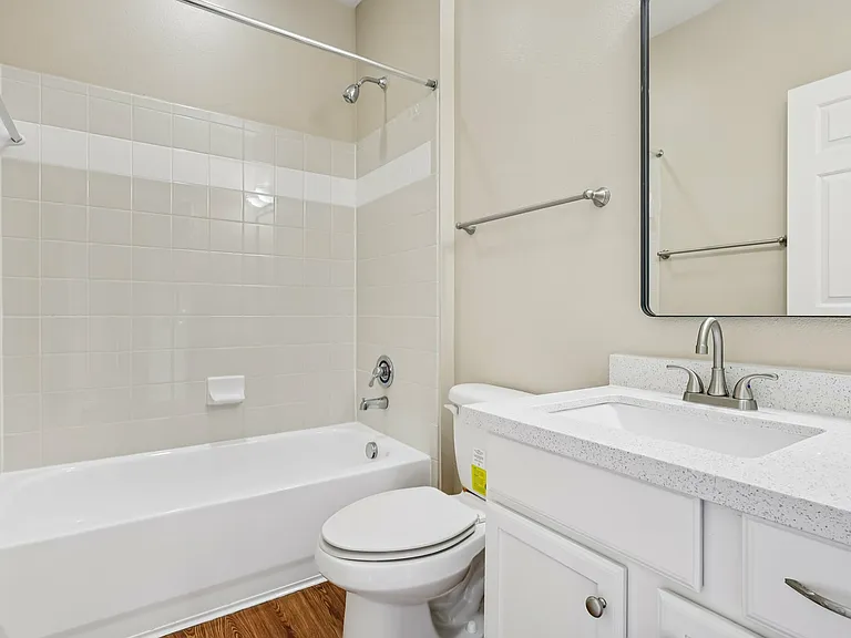 Elegant bathroom featuring a modern bathtub, sleek vanity with quartz countertop, and polished fixtures for a refreshing retreat. Elegant bathroom featuring a modern bathtub, sleek vanity with quartz countertop, and polished fixtures for a refreshing retr