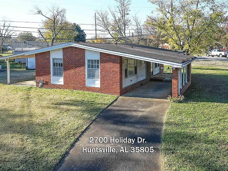 The front of the house is on the right & faces Bob Wallace. The two windows, on the side of house, face Holiday Dr. The left window is the master bedroom & the right window is the front or 2nd bedroom.
