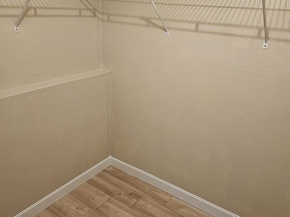 Walk-in closet in larger bedroom
