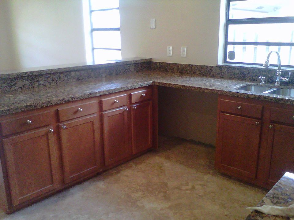 Kitchen w Granite and Stainless Steel appliances being put in