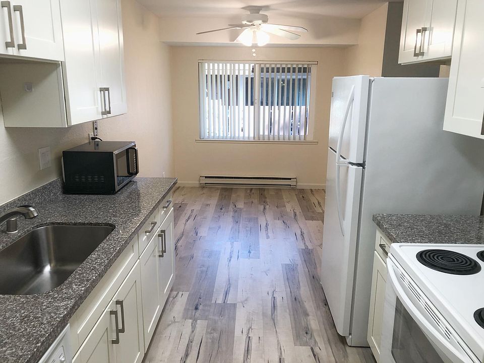 Unit 9 newly renovated kitchen and elegant flooring resembling hardwood.