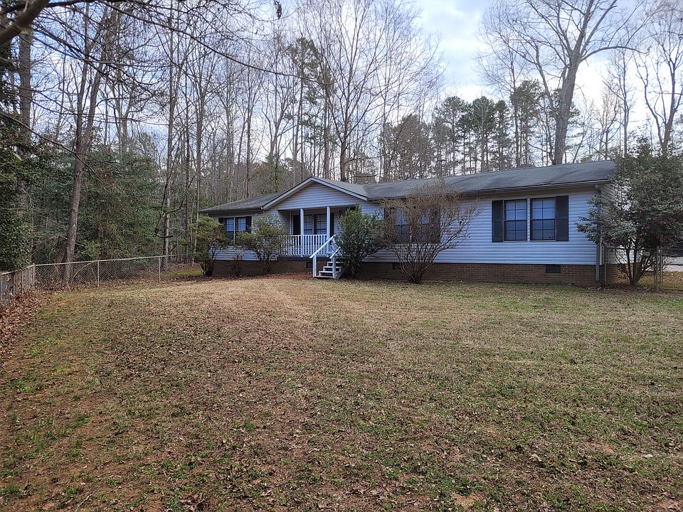 Front of the house with large fenced in lot.