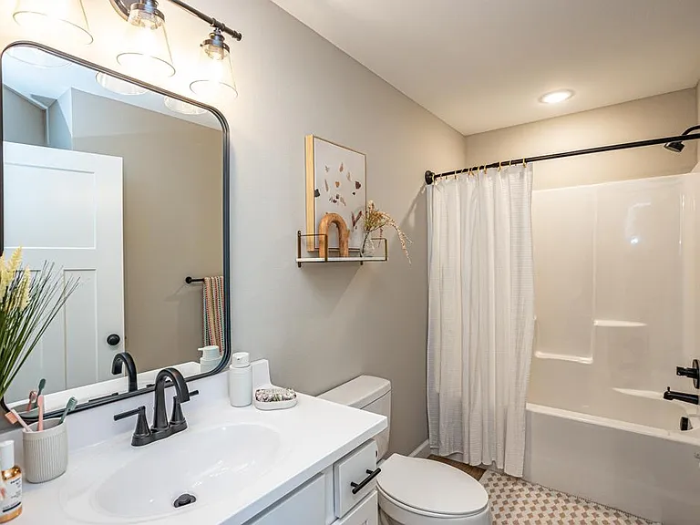 Second full bathroom featuring shower/tub combo and luxury vanity