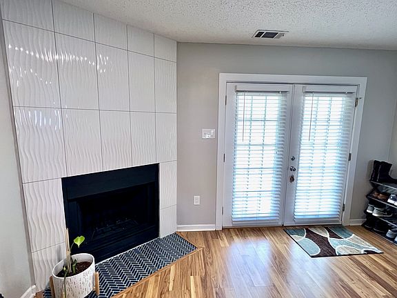 Decorative fireplace greets you at entry.