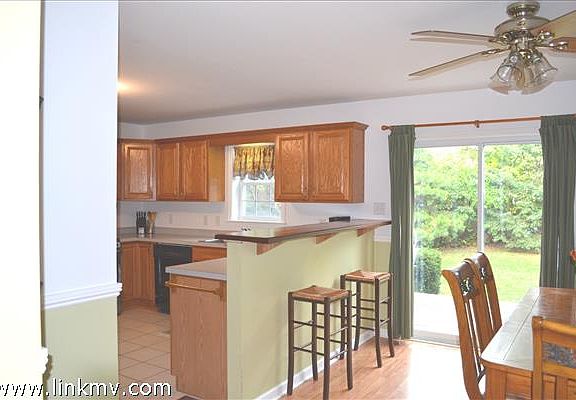 Eat in kitchen with breakfast bar with sliders that open to the deck