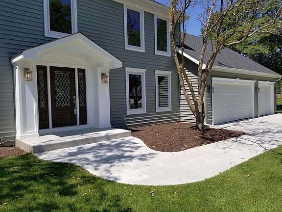 New concrete front stoop and extra wide sidewalk to driveway.