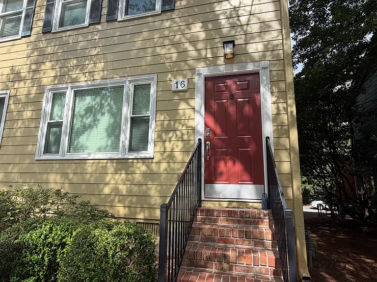 Front of unit with two parking spaces in front of the door