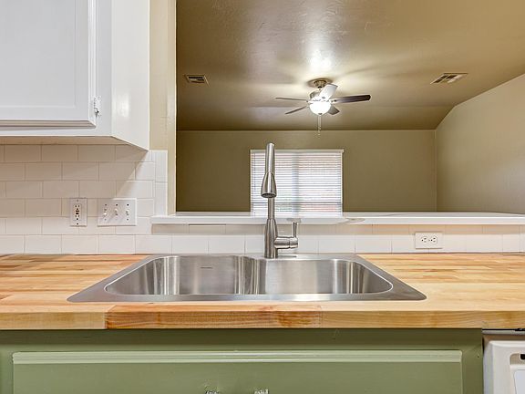 New sink, faucet fixture and garbage disposal. Bar top above is quartz and brand new also.
