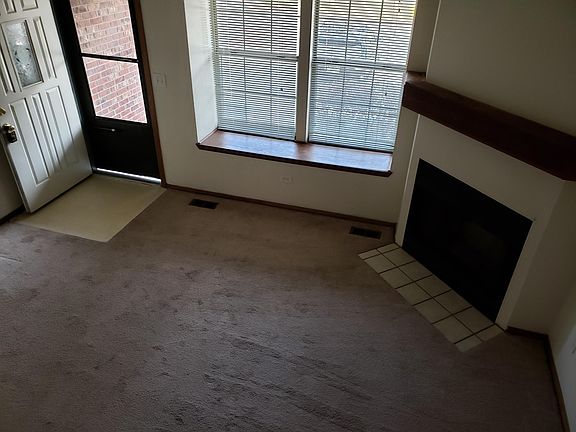 Living room view of fireplace and front door