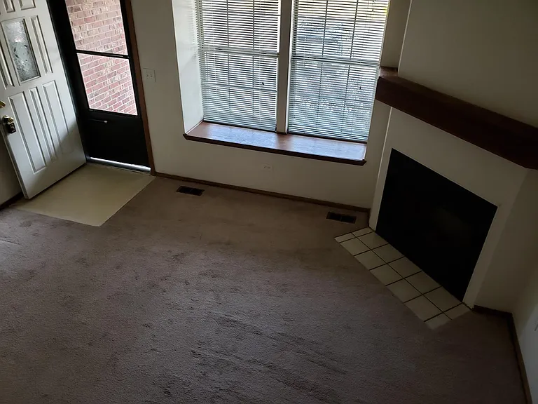 Living room view of fireplace and front door