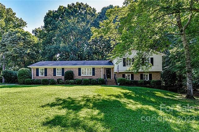 Beautiful front lawn with mature trees on a .9 acre lot.