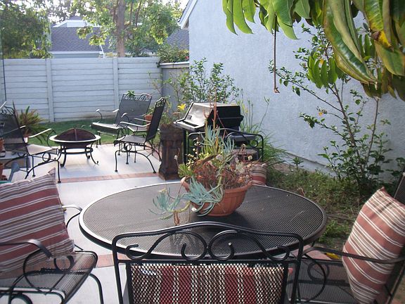 Oversized yard with patio and play area.