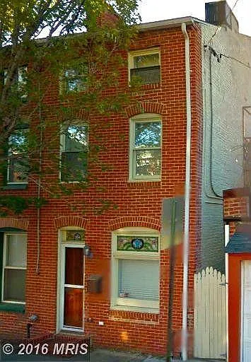 Front of house with private, gated alley.