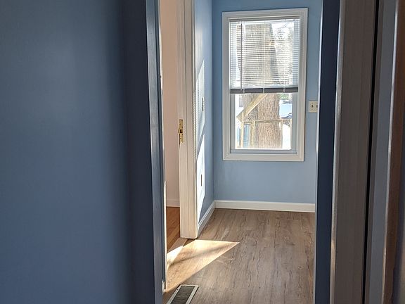 hall toward kitchen, door on left to living room