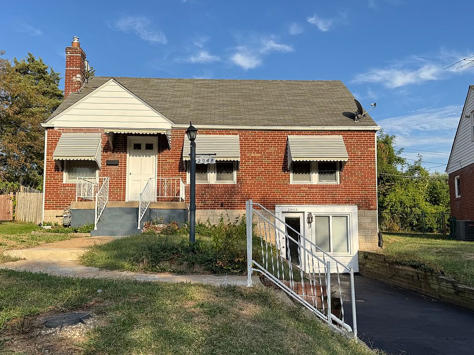 Front of house with driveway. Basement walk out door shown.
