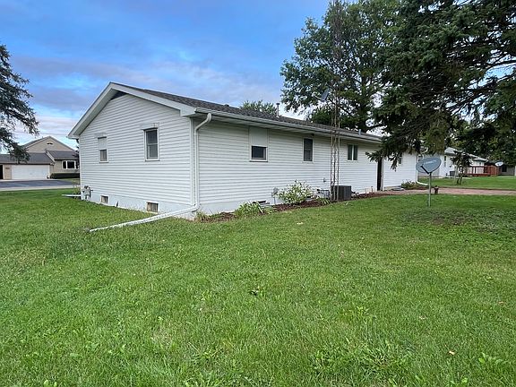 Easy to maintain flowerbeds and a brick patio in the back.