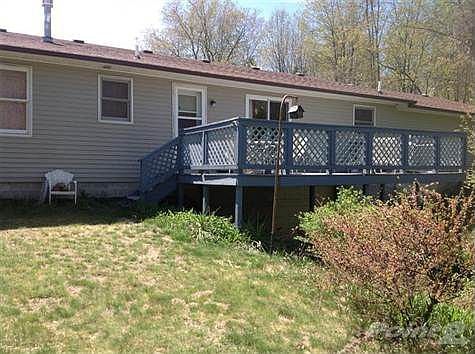 Back deck overlooks beautifully treed property